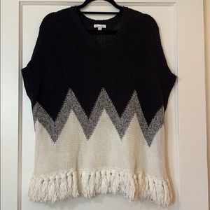Navy and white knit poncho with tassels
